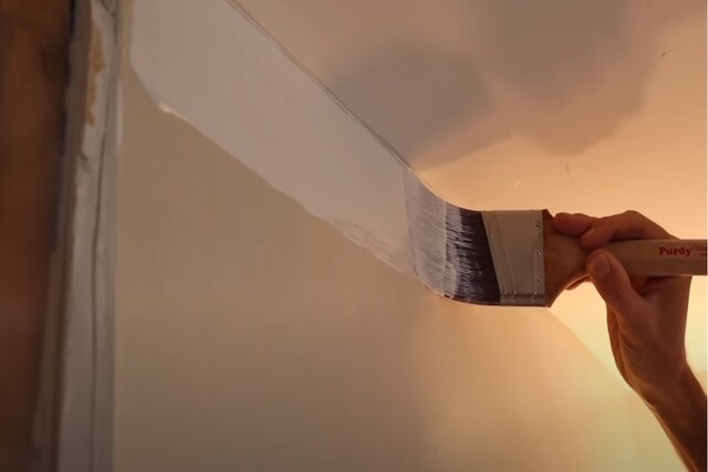 Interior Painter painting a wall with a brush